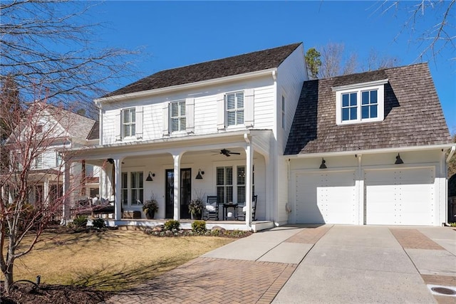 view of front of house featuring a porch, concrete driveway, and ceiling fan