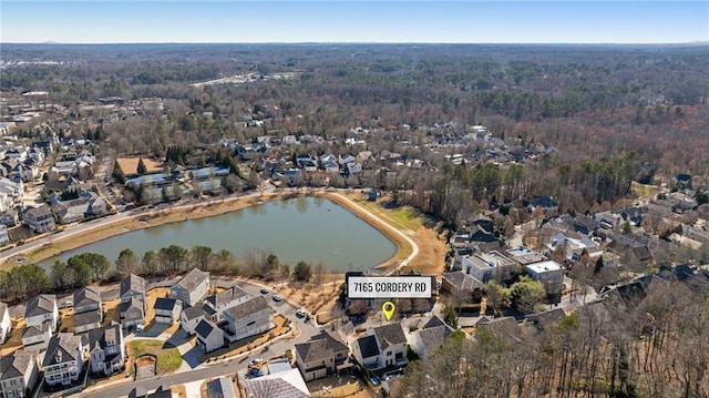 drone / aerial view featuring a residential view and a water view