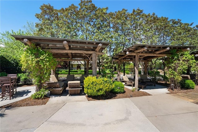 view of community with a pergola and a patio