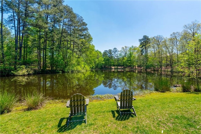 property view of water featuring a forest view