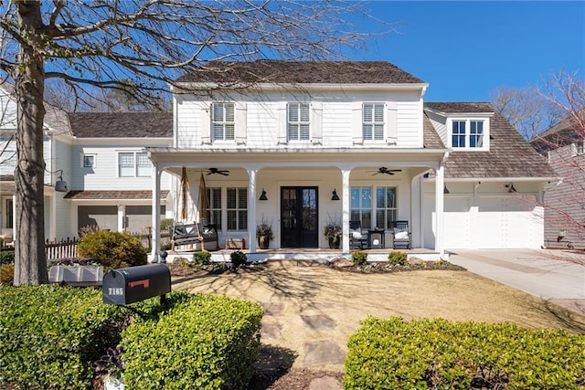 view of front of house featuring concrete driveway, a garage, covered porch, and ceiling fan