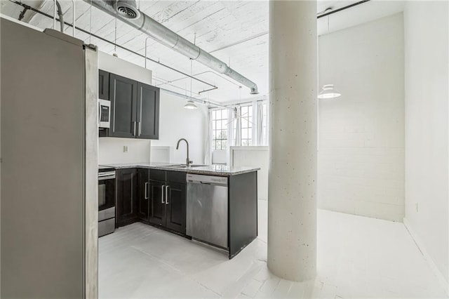 881 Memorial Dr SE Unit 307, Atlanta, GA 30316 - kitchen with appliances with stainless steel finishes, a sink, a peninsula, and dark cabinetry