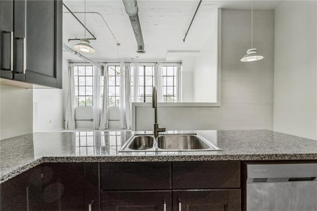 881 Memorial Dr SE Unit 307, Atlanta, GA 30316 - kitchen featuring stainless steel dishwasher, a sink, dark brown cabinets, and pendant lighting