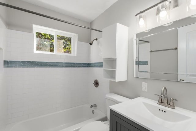 full bathroom featuring toilet, vanity, and tiled shower / bath