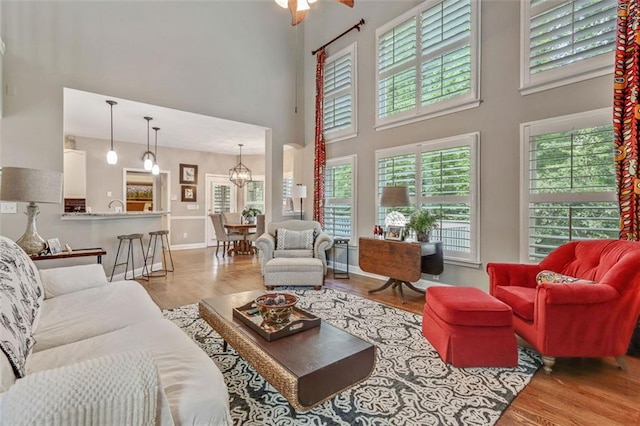 2073 Woodside Park Dr, Woodstock, GA 30188 - living room with a towering ceiling, wood finished floors, and a chandelier