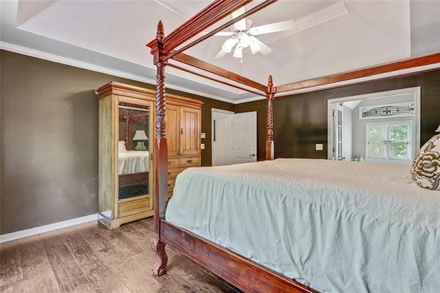 2073 Woodside Park Dr, Woodstock, GA 30188 - bedroom with a tray ceiling, ornamental molding, wood finished floors, and ceiling fan