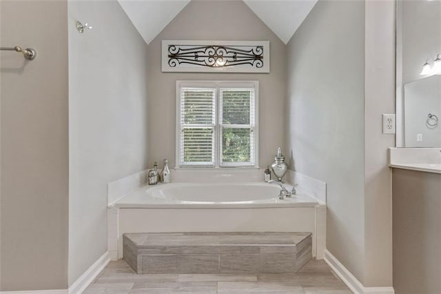2073 Woodside Park Dr, Woodstock, GA 30188 - bathroom with a bath, vanity, lofted ceiling, and wood finished floors