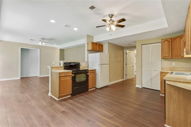 2073 Woodside Park Dr, Woodstock, GA 30188 - kitchen with black electric range oven, freestanding refrigerator, ceiling fan, light countertops, and recessed lighting