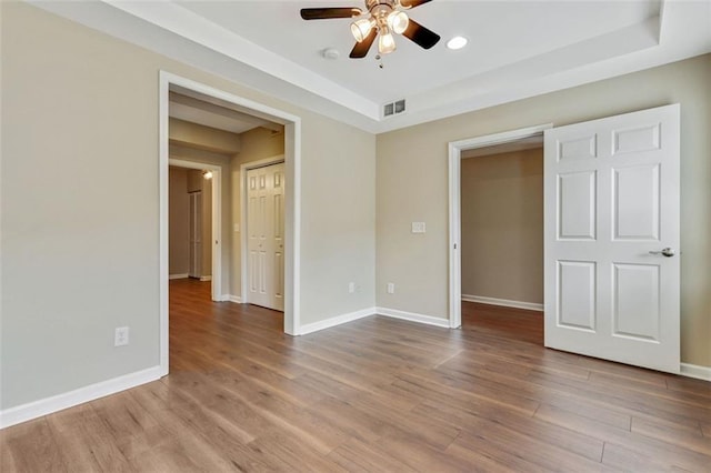 2073 Woodside Park Dr, Woodstock, GA 30188 - unfurnished room featuring ceiling fan, wood finished floors, a raised ceiling, and a smoke detector
