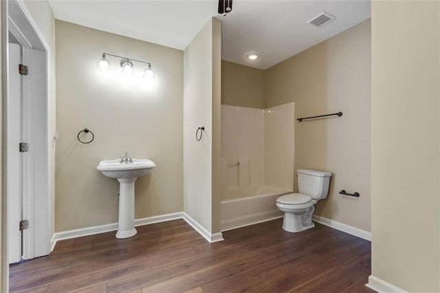 2073 Woodside Park Dr, Woodstock, GA 30188 - bathroom with wood finished floors and shower / tub combination