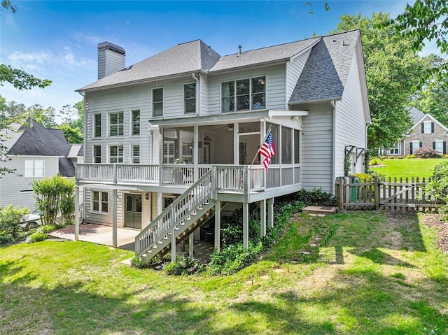2073 Woodside Park Dr, Woodstock, GA 30188 - back of property with a sunroom, a patio, stairway, a chimney, and a wooden deck