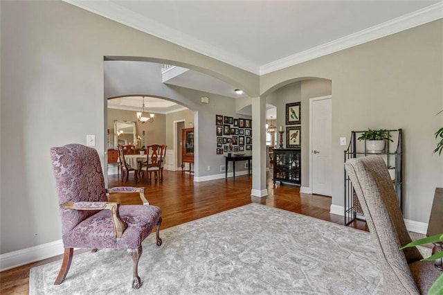 2073 Woodside Park Dr, Woodstock, GA 30188 - living area featuring ornamental molding, wood finished floors, arched walkways, and a chandelier
