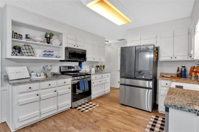 kitchen with open shelves, visible vents, appliances with stainless steel finishes, light wood-style floors, and white cabinets