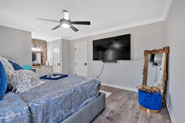 bedroom featuring baseboards, ornamental molding, ceiling fan, and wood finished floors