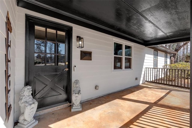 view of exterior entry with covered porch