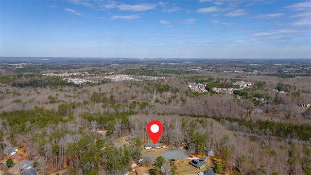 aerial view featuring a wooded view