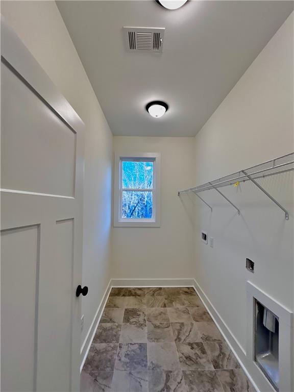 laundry room with laundry area, baseboards, visible vents, hookup for a washing machine, and hookup for an electric dryer