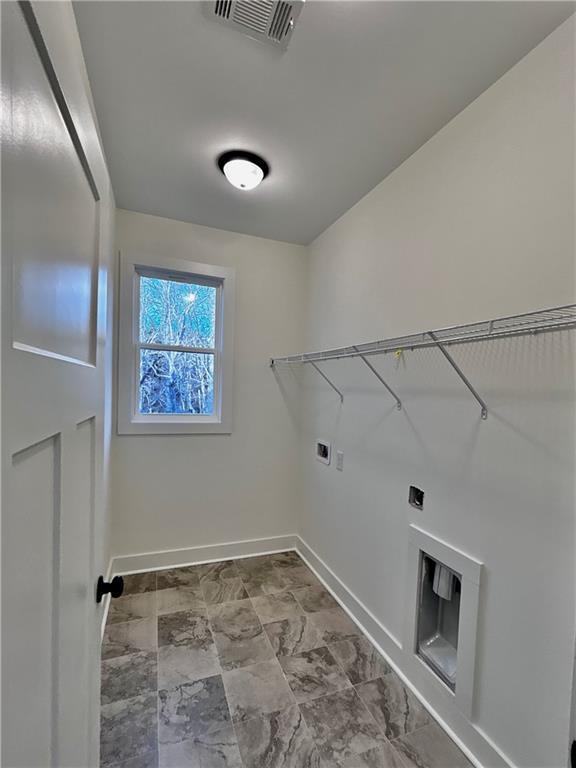 laundry area featuring hookup for a washing machine, visible vents, electric dryer hookup, laundry area, and baseboards