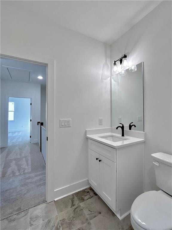 bathroom with marble finish floor, vanity, toilet, and baseboards