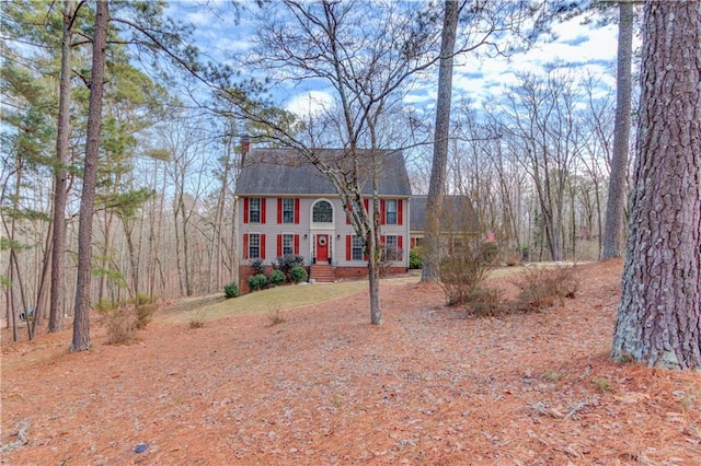 colonial house featuring a chimney