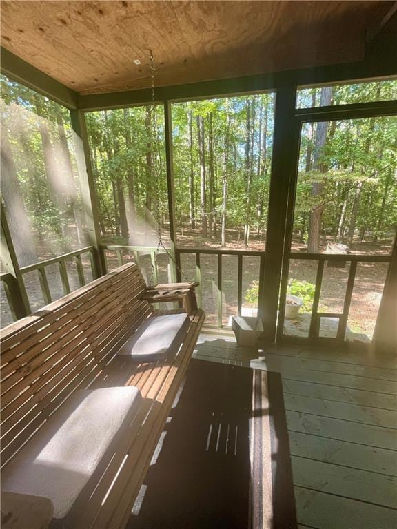 unfurnished sunroom with wooden ceiling