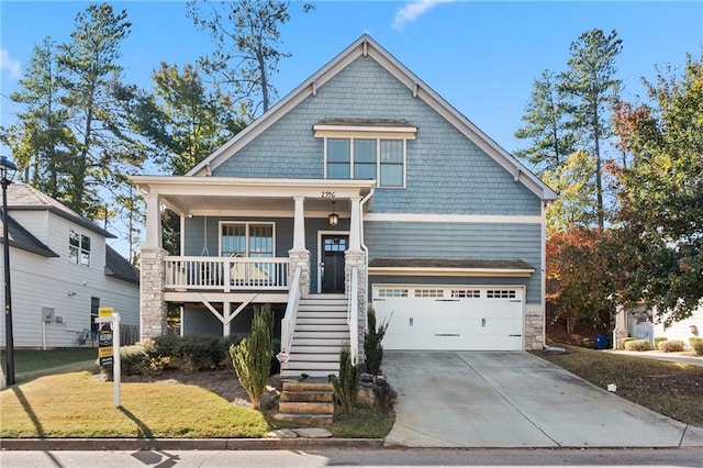 craftsman inspired home featuring a garage, a front lawn, and a porch