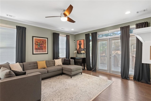 living room featuring ornamental molding, ceiling fan, and dark hardwood / wood-style flooring