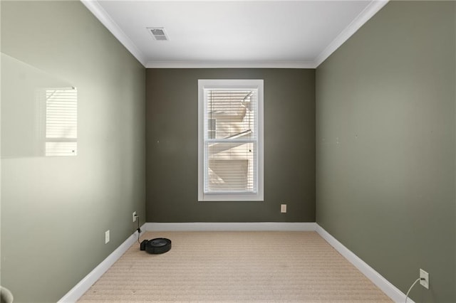 empty room with crown molding and light colored carpet