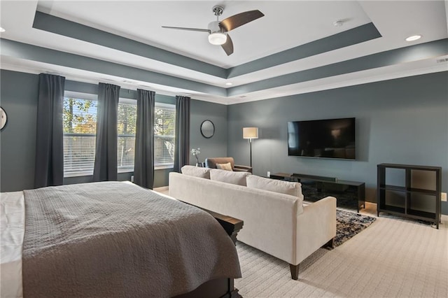 bedroom featuring ceiling fan and a tray ceiling