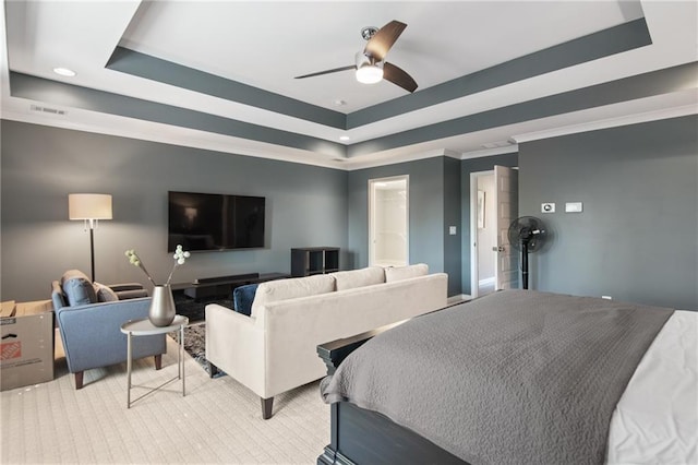 bedroom with ornamental molding, ceiling fan, and a raised ceiling