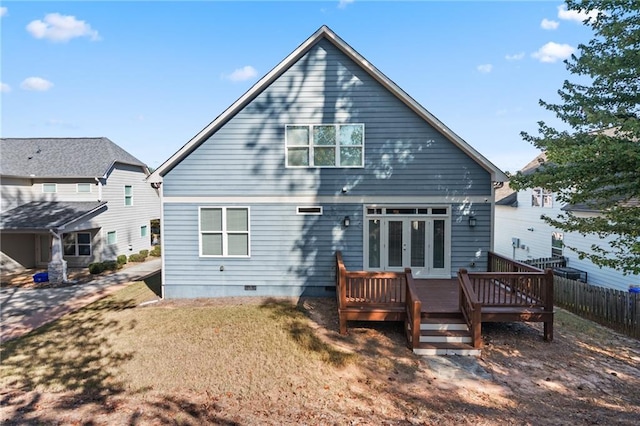 back of house featuring a yard and a deck