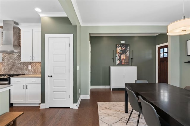 dining area with ornamental molding and dark hardwood / wood-style flooring