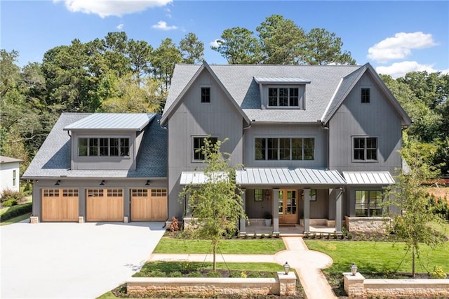 modern farmhouse with a garage and a front lawn