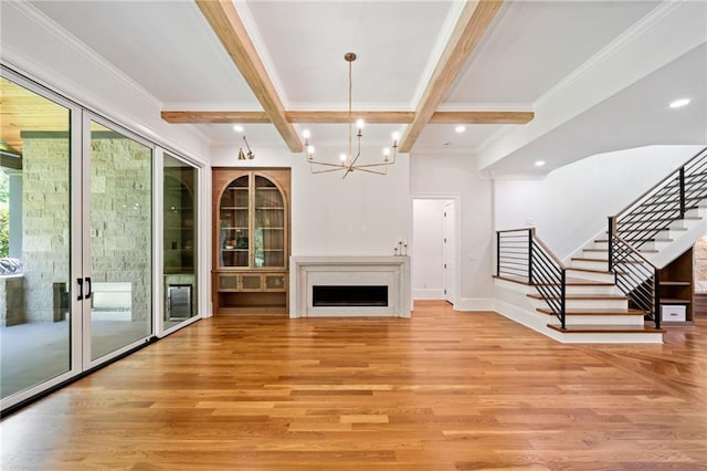 115 Baxley Ln, Alpharetta, GA 30004 - unfurnished living room with stairway, light wood-style flooring, an inviting chandelier, and coffered ceiling