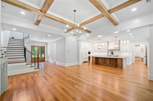 115 Baxley Ln, Alpharetta, GA 30004 - unfurnished living room featuring a notable chandelier, light wood-type flooring, baseboards, beam ceiling, and coffered ceiling