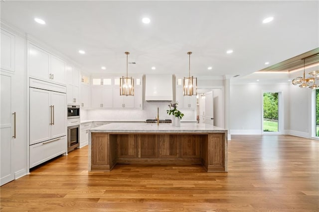 115 Baxley Ln, Alpharetta, GA 30004 - kitchen featuring ornamental molding, paneled refrigerator, a chandelier, white cabinetry, and light wood finished floors
