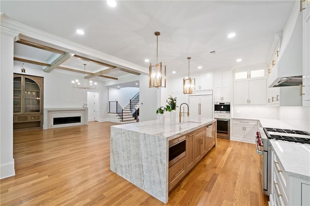 115 Baxley Ln, Alpharetta, GA 30004 - kitchen with an inviting chandelier, built in appliances, a sink, beam ceiling, and custom range hood