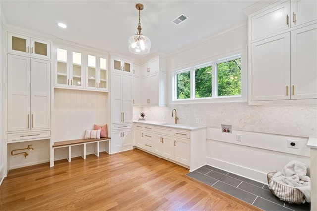 115 Baxley Ln, Alpharetta, GA 30004 - interior space featuring light wood finished floors, visible vents, a sink, and crown molding