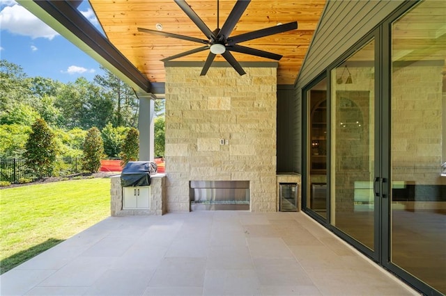 115 Baxley Ln, Alpharetta, GA 30004 - view of patio / terrace with area for grilling, fence, a ceiling fan, and an outdoor stone fireplace