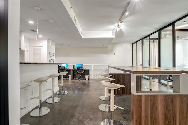 bar featuring recessed lighting, visible vents, concrete floors, and track lighting