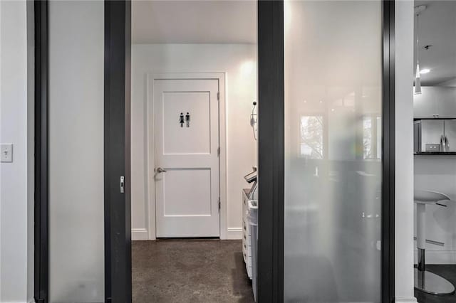 hallway with concrete flooring