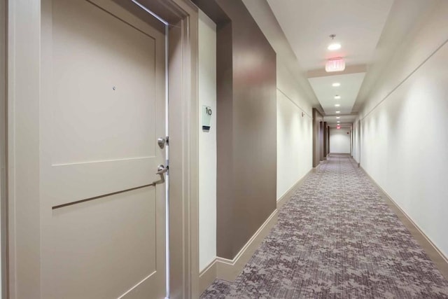 hallway with carpet flooring, recessed lighting, and baseboards