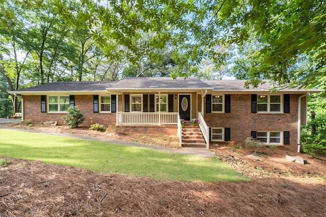 71 Seminole Trl SW, Cartersville, GA 30120 - ranch-style house with brick siding, a porch, and a front lawn
