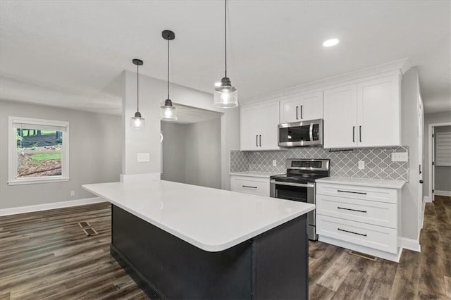 71 Seminole Trl SW, Cartersville, GA 30120 - kitchen with appliances with stainless steel finishes, baseboards, light countertops, white cabinets, and recessed lighting