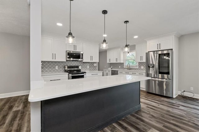 71 Seminole Trl SW, Cartersville, GA 30120 - kitchen with stainless steel appliances, baseboards, a sink, white cabinets, and recessed lighting