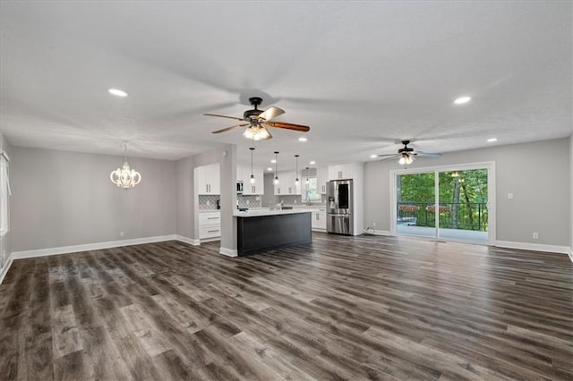 71 Seminole Trl SW, Cartersville, GA 30120 - unfurnished living room with ceiling fan, a chandelier, recessed lighting, baseboards, and dark wood finished floors