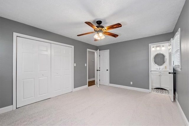 71 Seminole Trl SW, Cartersville, GA 30120 - unfurnished bedroom featuring light colored carpet, baseboards, a textured ceiling, ensuite bath, and a ceiling fan