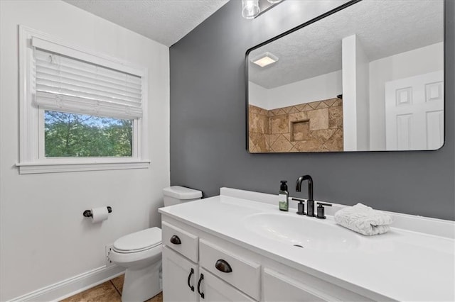 71 Seminole Trl SW, Cartersville, GA 30120 - bathroom featuring a textured ceiling, toilet, vanity, baseboards, and tile patterned flooring