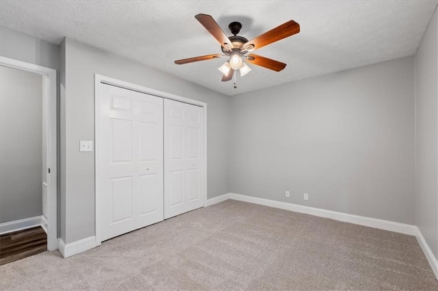 71 Seminole Trl SW, Cartersville, GA 30120 - unfurnished bedroom featuring carpet, a closet, baseboards, a textured ceiling, and ceiling fan