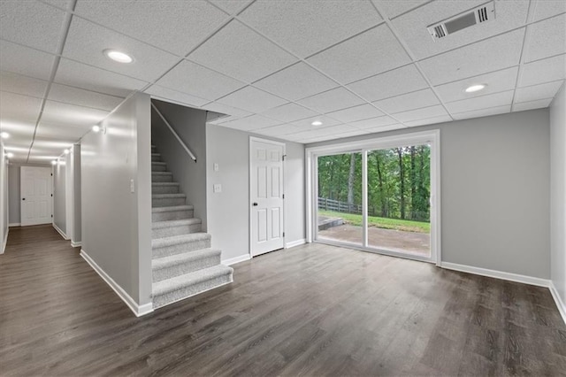 71 Seminole Trl SW, Cartersville, GA 30120 - unfurnished living room featuring baseboards, dark wood-style flooring, stairs, a drop ceiling, and recessed lighting